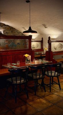 Tables and chairs inside The Cellar Restaurant