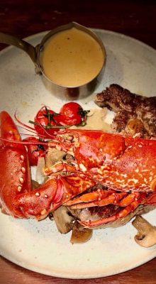 Lobster and steak on plate