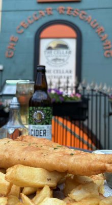 Fish and chips on table outside The Cellar Restaurant